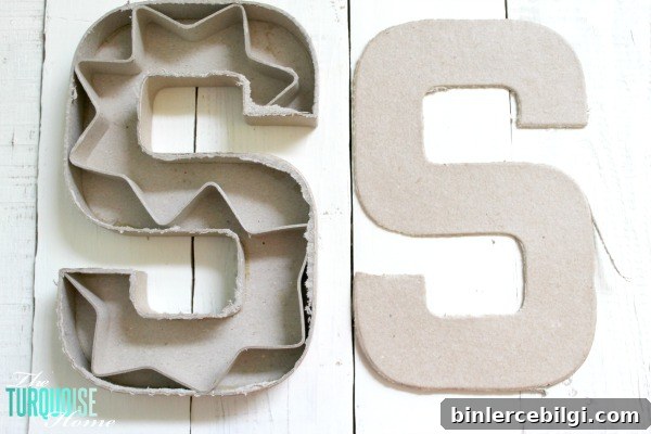 Cut the top off of a simple paper mache initial from Hobby Lobby and fill it with moss and flowers for a sweet addition to a baby girl's nursery. | DIY Flower and Moss Initial Art via TheTurquoiseHome.com