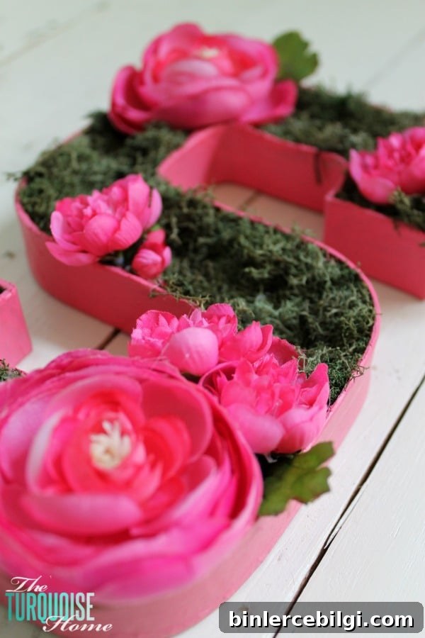 I love this sweet and simple DIY project - perfect for a baby girl's nursery | DIY Flower and Moss Initial Art via TheTurquoiseHome.com