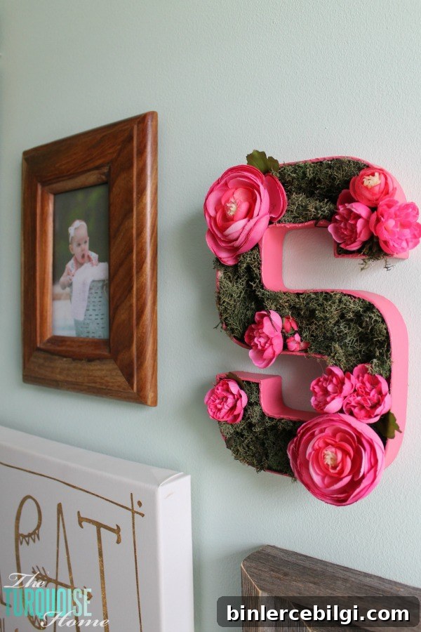 I love this sweet and simple DIY project - perfect for a baby girl's nursery | DIY Flower and Moss Initial Art via TheTurquoiseHome.com