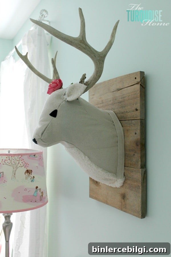 All of the pretty pink and turquoise touches with a woodland theme make a sweet retreat for any little girl. | Baby Girl's Woodland Nursery | All the details at TheTurquoiseHome.com