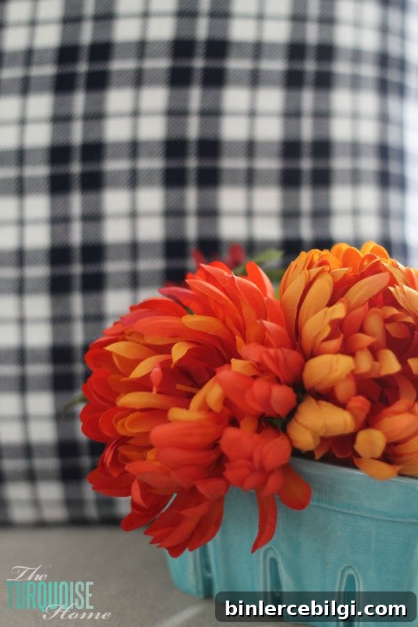 Fall mantel styling with plaid throw and pumpkins