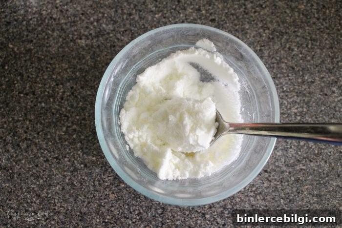 Applying baking soda paste to glass stove top