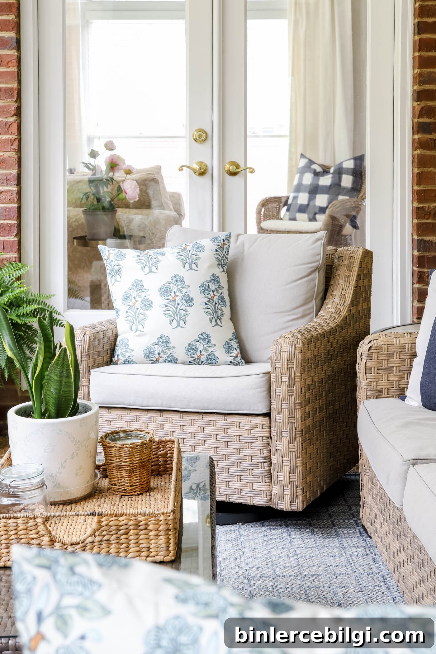 Floral pillow covers on wicker patio furniture