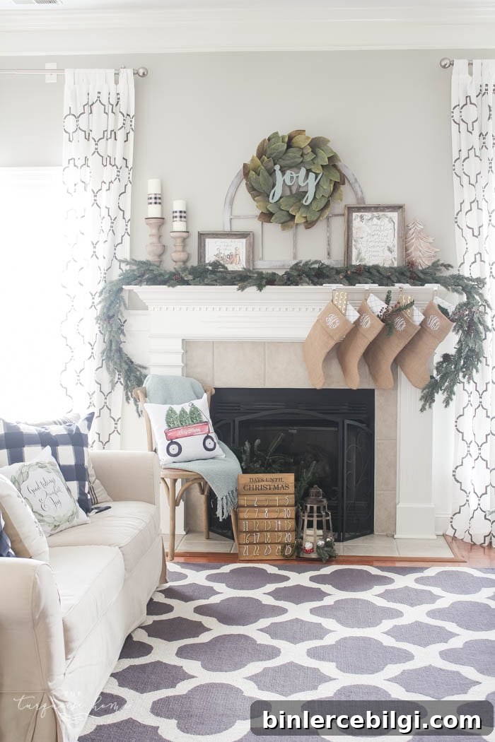 Pretty magnolia wreath Christmas mantel decor brings a rustic feel to the holiday season. Pops of navy and dusty blue are festive, yet unexpected! | Gorgeous Magnolia Wreath Christmas Mantel Decor