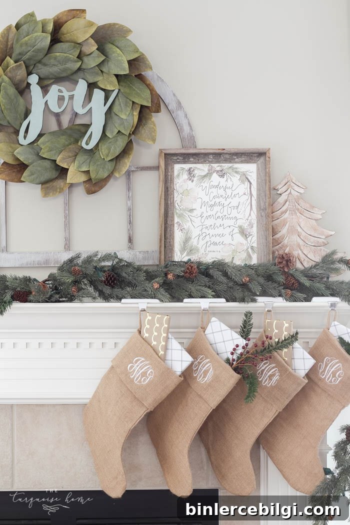 Pretty magnolia wreath Christmas mantel decor brings a rustic feel to the holiday season. Pops of navy and dusty blue are festive, yet unexpected! | Gorgeous Magnolia Wreath Christmas Mantel Decor