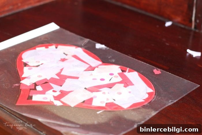 We used this in my daughter's Kindergarten class party! The kids LOVED it! | DIY Tissue Paper Sun Catcher Valentine's Kid Craft