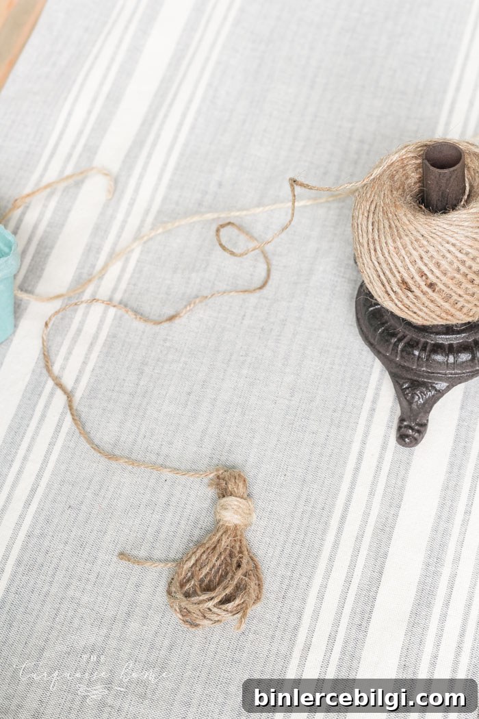 Wrapping the top of the tassel with jute for a finished look.