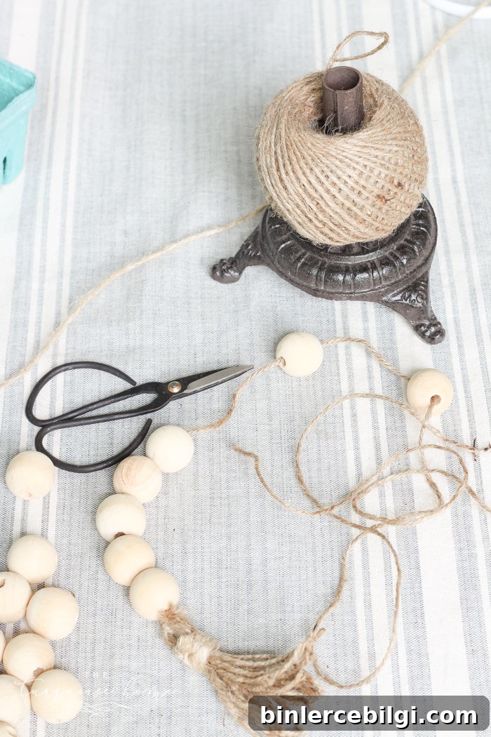 Stringing wood beads onto the jute twine for the garland.