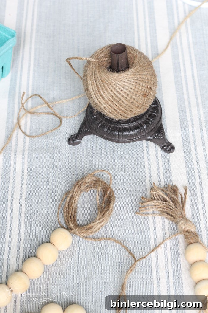 Adding the second tassel to complete the wood bead garland.