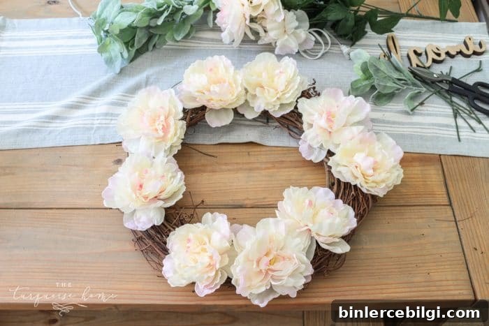 Add the peonies first to the lamb's ear wreath.