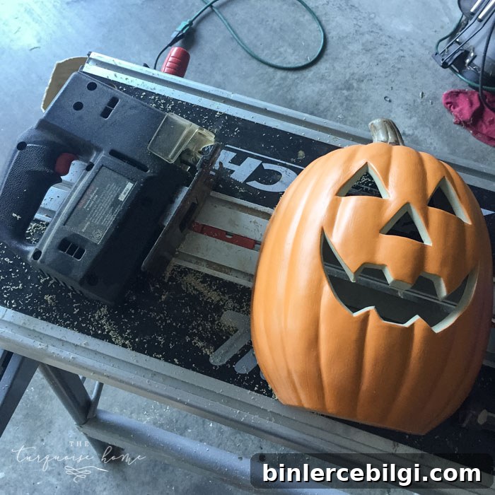 Cut the pumpkin in half for the DIY Lighted Pumpkin Candy Holder