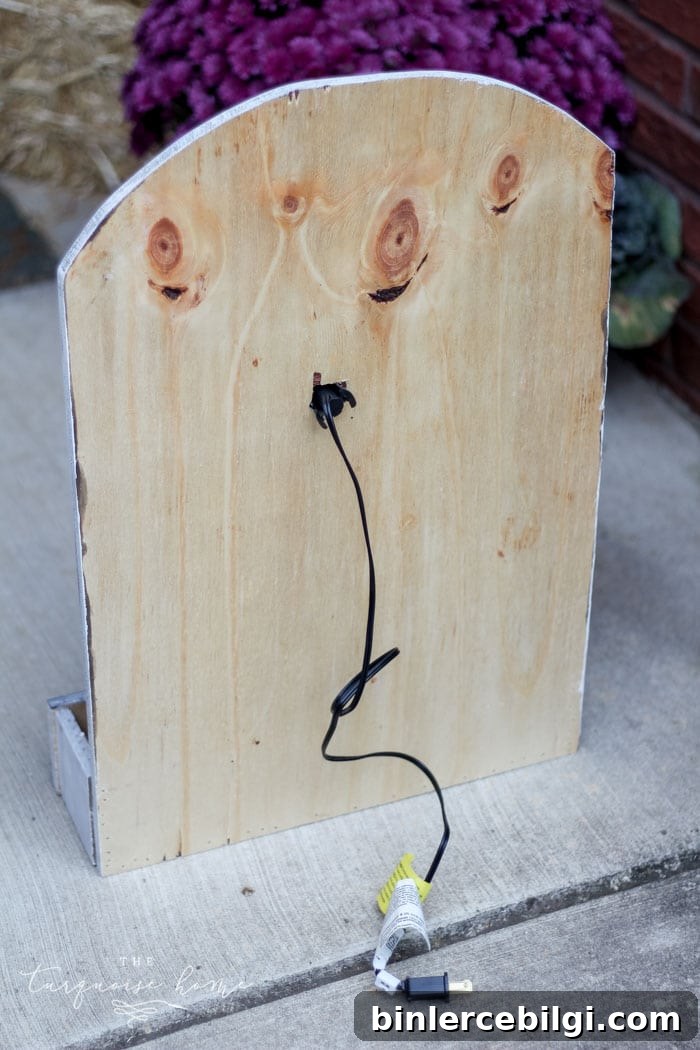Attach the light to the hole in the back of the board for your lighted pumpkin candy holder! Plug it in and voila - the cutest jack-o-lantern candy holder you've ever seen!