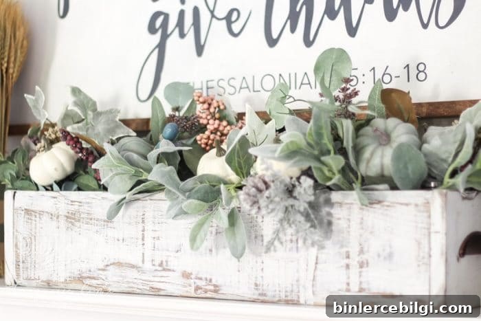 Adorable faux foliage centerpiece made with a wooden box, mason jars and faux stems. LOVE!