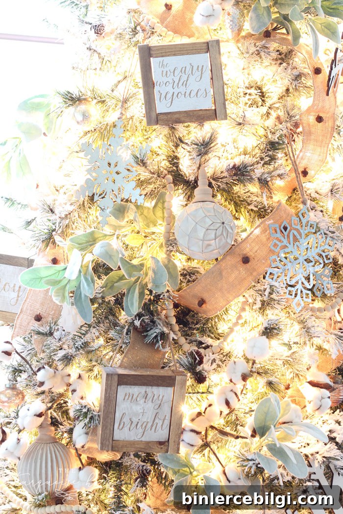 My Flocked Farmhouse Christmas Tree - super cute cotton stems, lamb's ear, galvanized snowflakes, and wooden bead garland.
