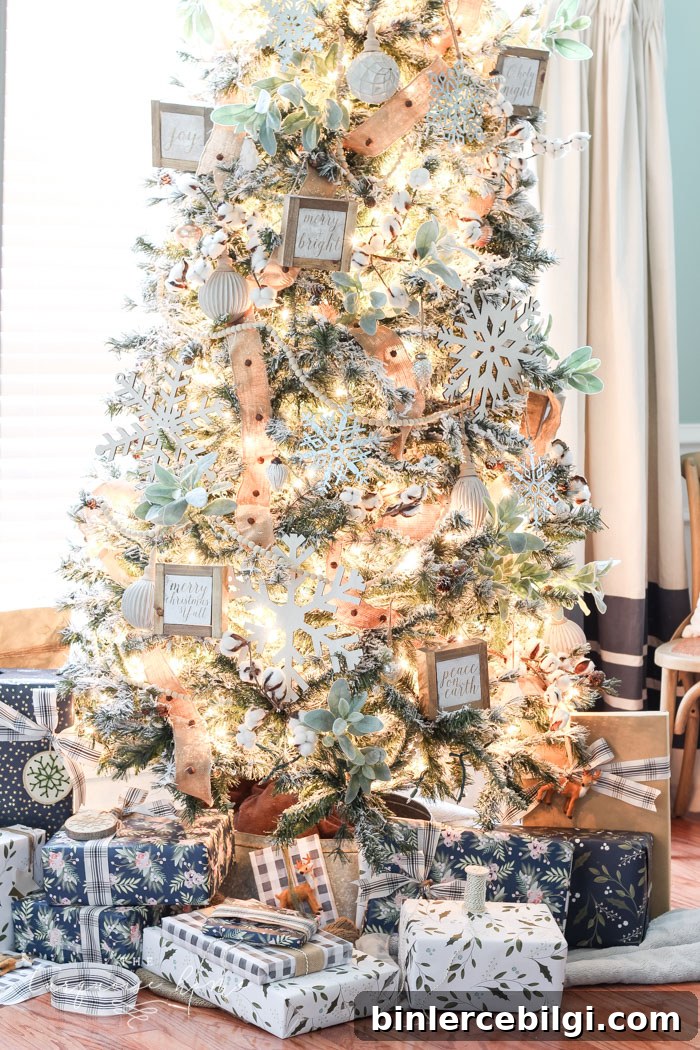 My Flocked Farmhouse Christmas Tree - super cute cotton stems, lamb's ear, galvanized snowflakes, and wooden bead garland.