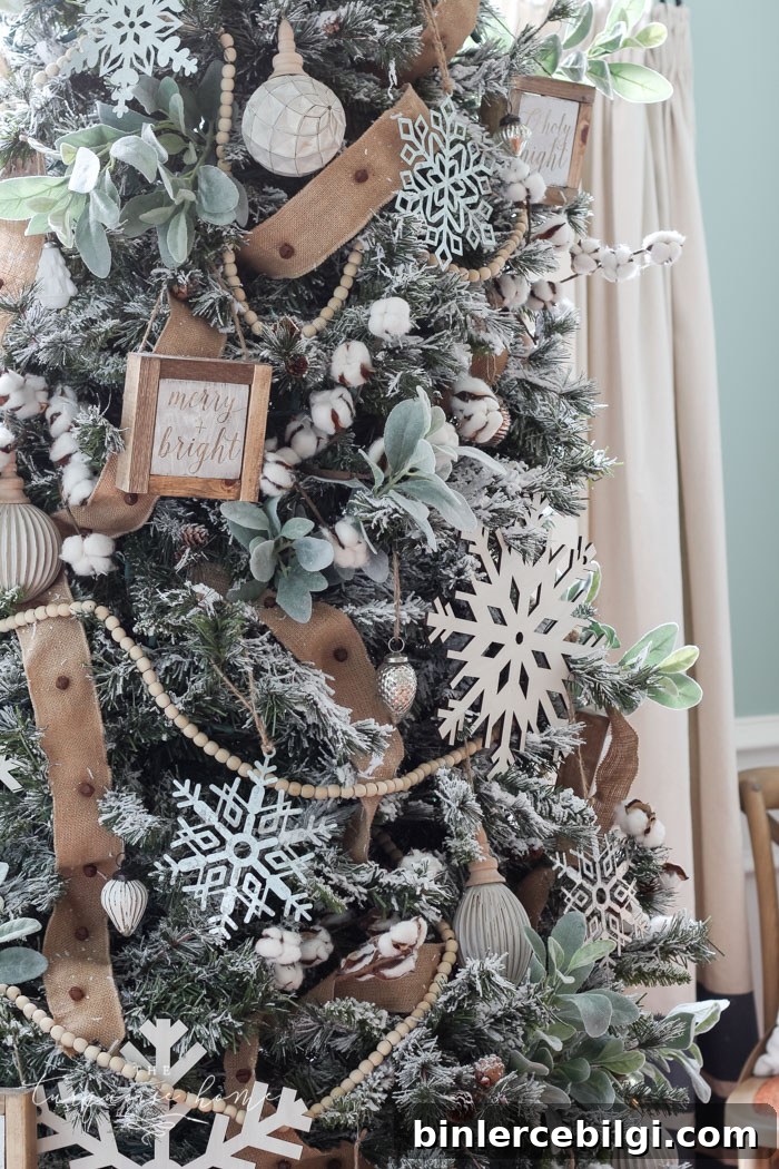 My Flocked Farmhouse Christmas Tree - super cute cotton stems, lamb's ear, galvanized snowflakes, and wooden bead garland.