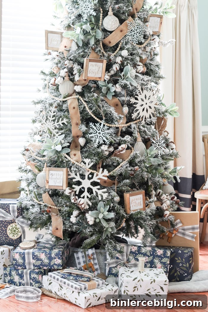 My Flocked Farmhouse Christmas Tree - super cute cotton stems, lamb's ear, galvanized snowflakes, and wooden bead garland.