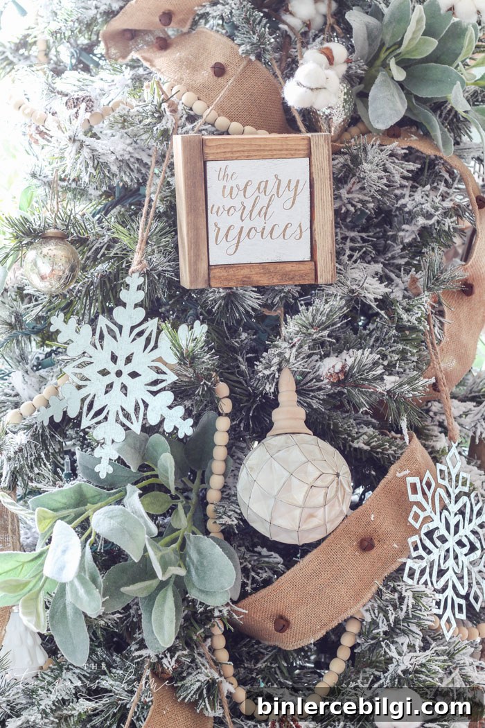 My Flocked Farmhouse Christmas Tree - super cute cotton stems, lamb's ear, galvanized snowflakes, and wooden bead garland.