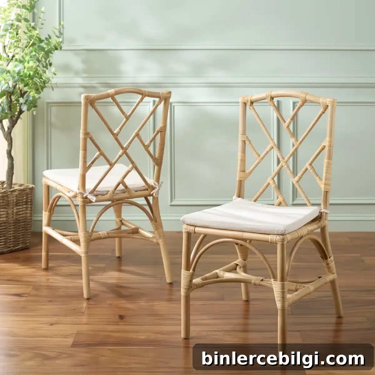 Natural woven rattan dining chairs with removable white cushions in a coastal dining room style.