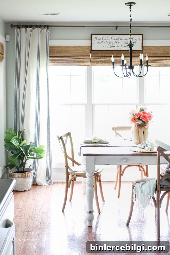 Bamboo shades and striped curtains refresh the kitchen