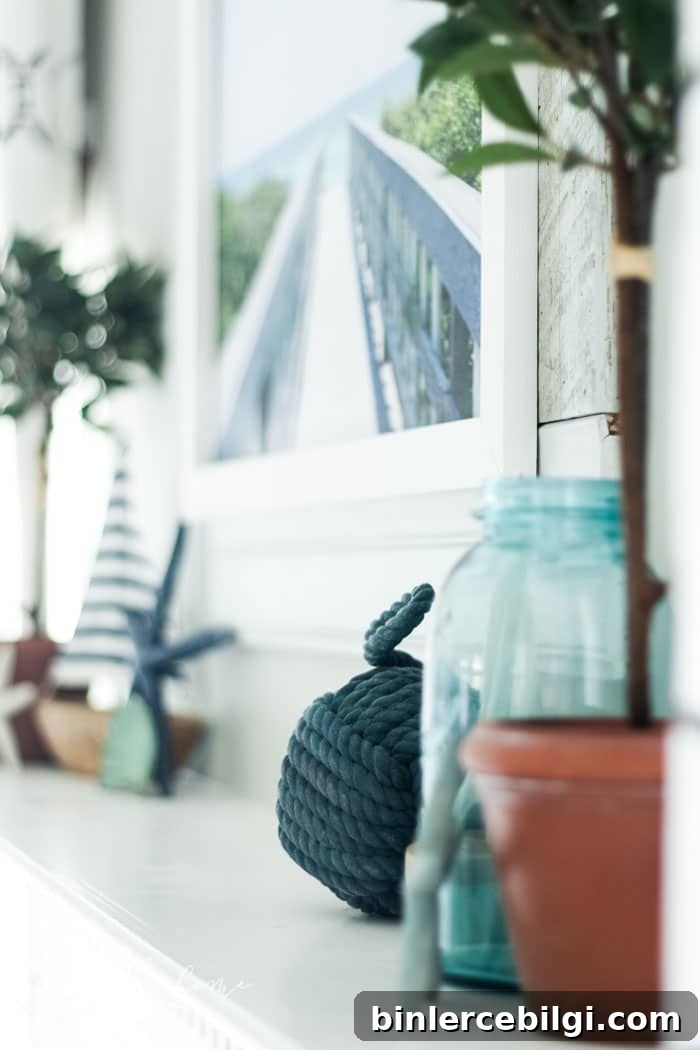 Add a little nautical charm to your living space with these simple coastal summer mantel decor ideas. Featuring DIY beach canvas art, blue & white starfish, textured sailor's knot and cheerfully striped sail boats, this mantel looks great for the seasonally inspired.