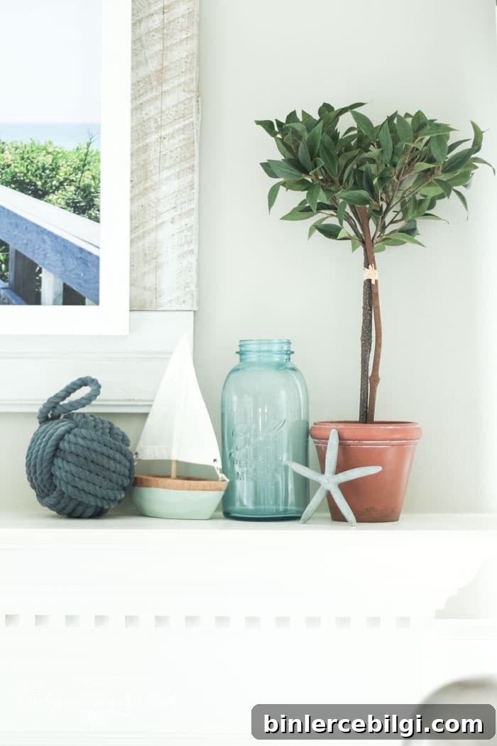 Add a little nautical charm to your living space with these simple coastal summer mantel decor ideas. Featuring DIY beach canvas art, blue & white starfish, textured sailor's knot and cheerfully striped sail boats, this mantel looks great for the seasonally inspired.