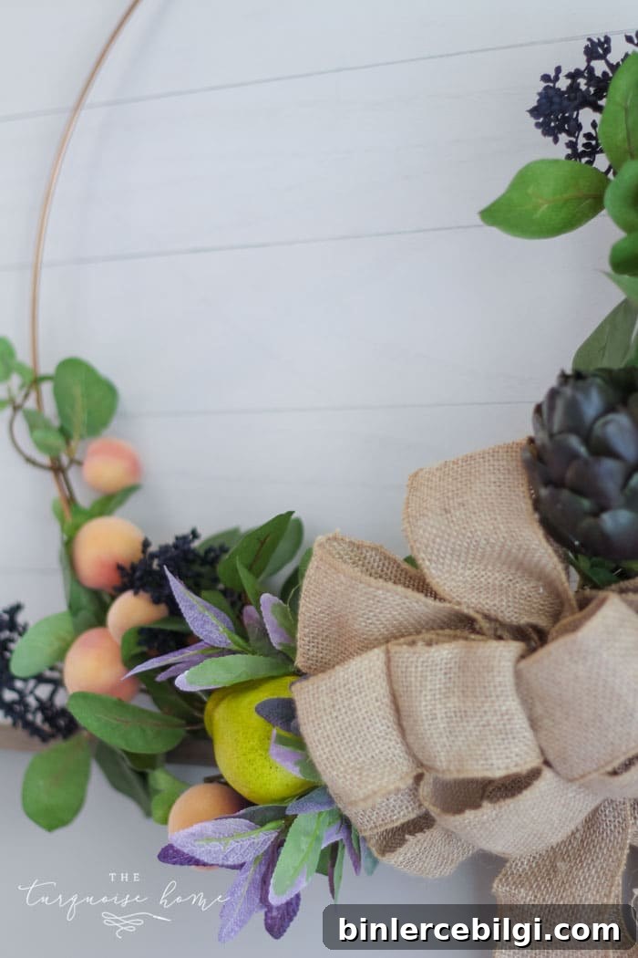 Add a burlap bow to the center of the hoop wreath to cover up all of the stems and floral wire in the middle!
