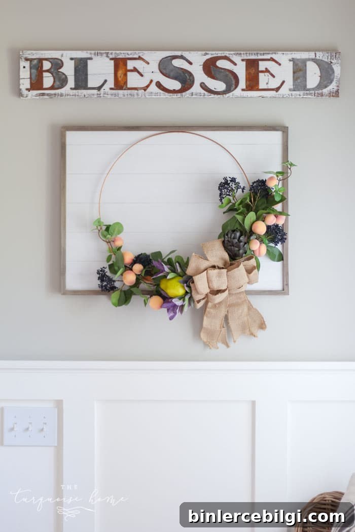 Gorgeous fall wreath with fruit on a "shiplap" framed backdrop.