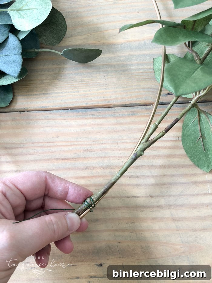 Attach the floral and fruit stems to the wreath hoop.