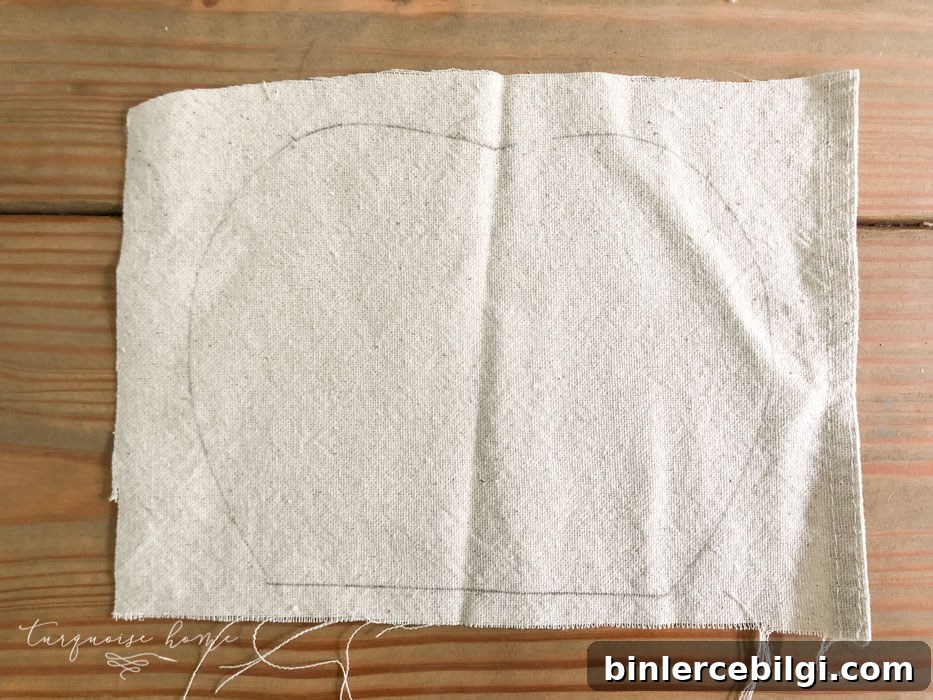 Trace the outline of the wooden pumpkin on the cloth.