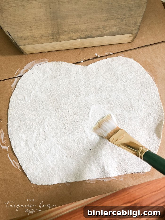 Use Mod Podge to glue the drop cloth to the pumpkin.