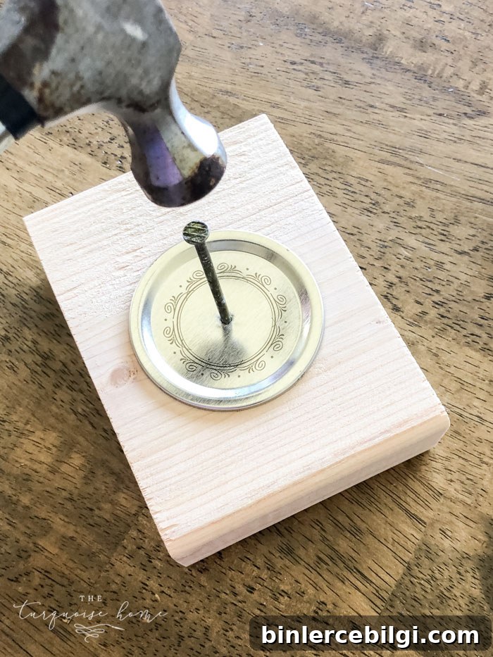 Hammer a nail to make a hanger hole in the lid