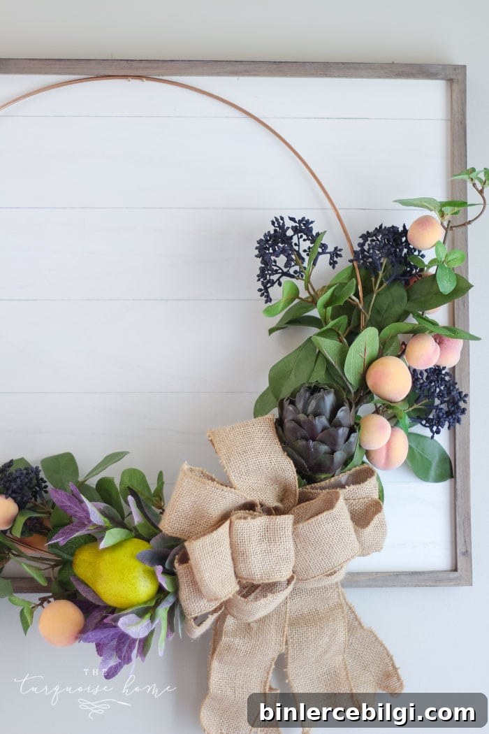 Budget-Friendly Fall Decor Ideas for a Cozy Home 7 Gorgeous fall wreath with fruit on a "shiplap" framed backdrop.
