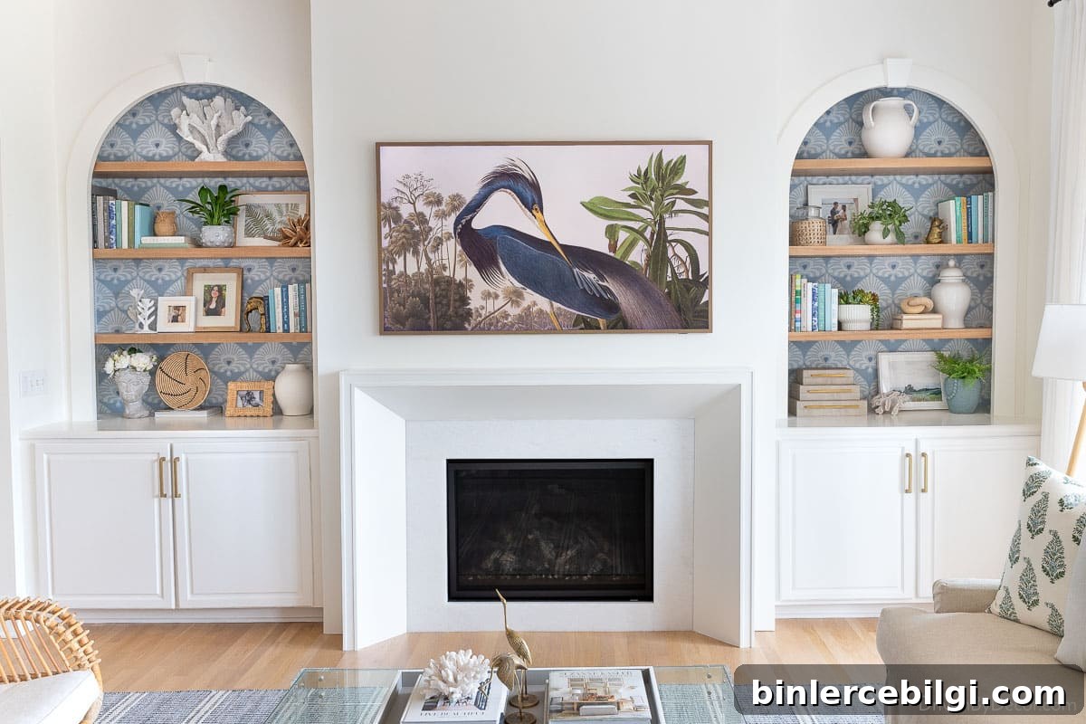styled bookcases flanking a modern white fireplace