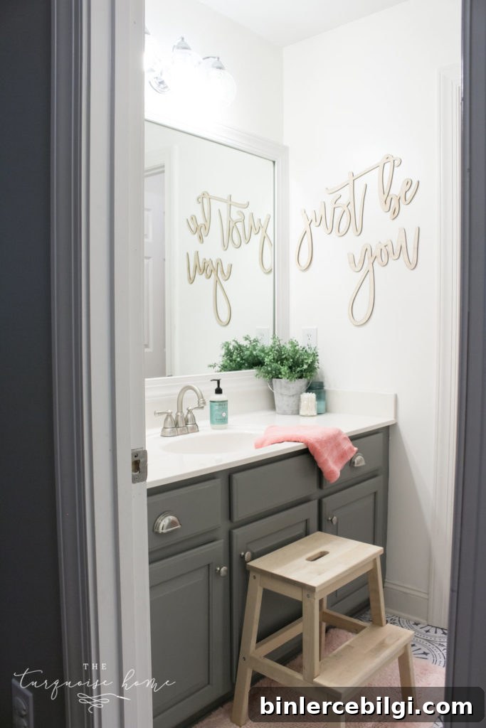 How to Create Big Style in a Small Bathroom | The Girls' Bathroom Refresh Reveal | Wooden Step Stool | Pink Towels | Gray painted cabinets
