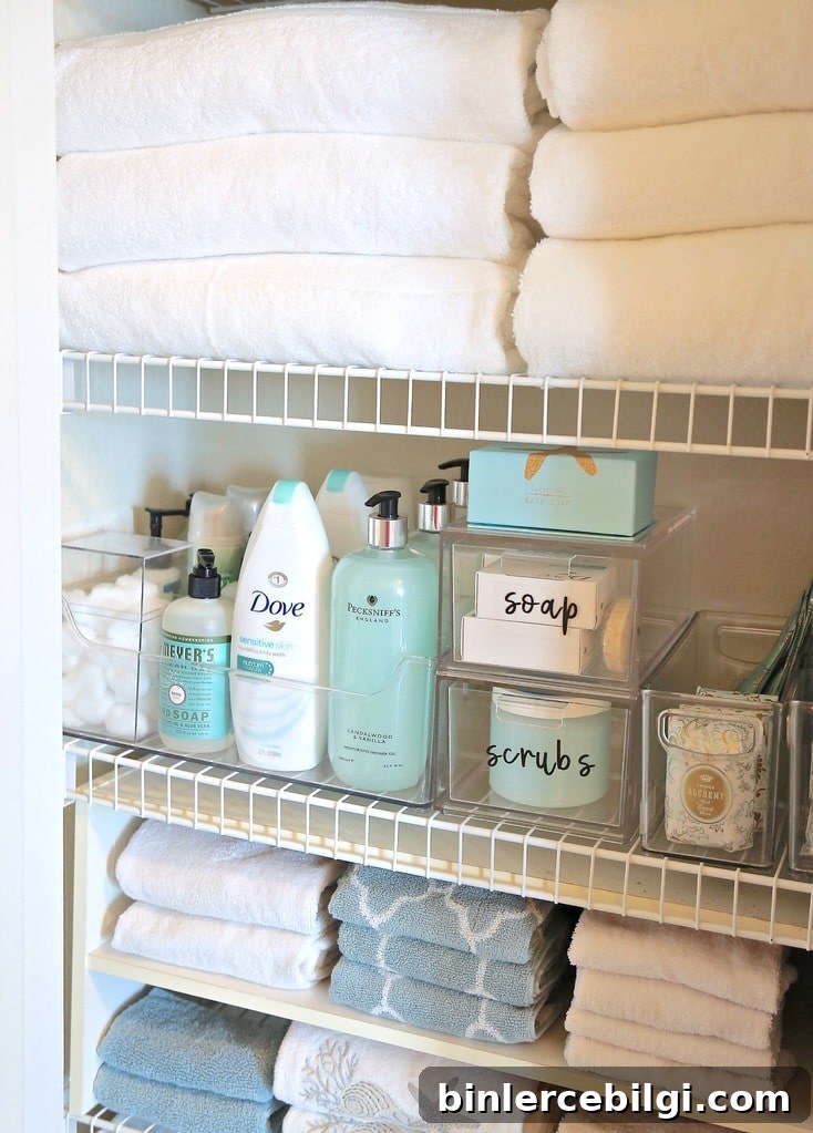 Organized linen closet with clear bins and labels