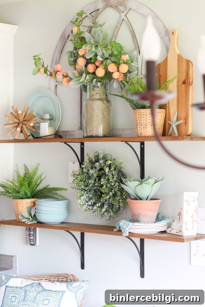 Open Kitchen Shelves Decorated for Summer - peach stems, turquoise dishes and lots of greenery