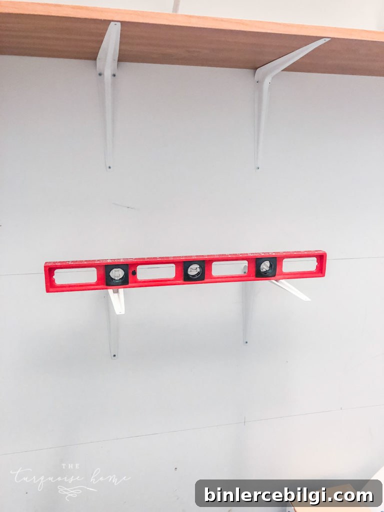 DIY Closet Shelves: Step-by-Step Beginner Guide 6 Use a level to keep the brackets straight when installing the pantry shelves.
