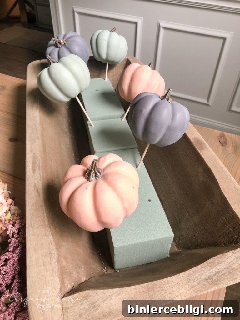 Add the largest pumpkins to the floral foam first