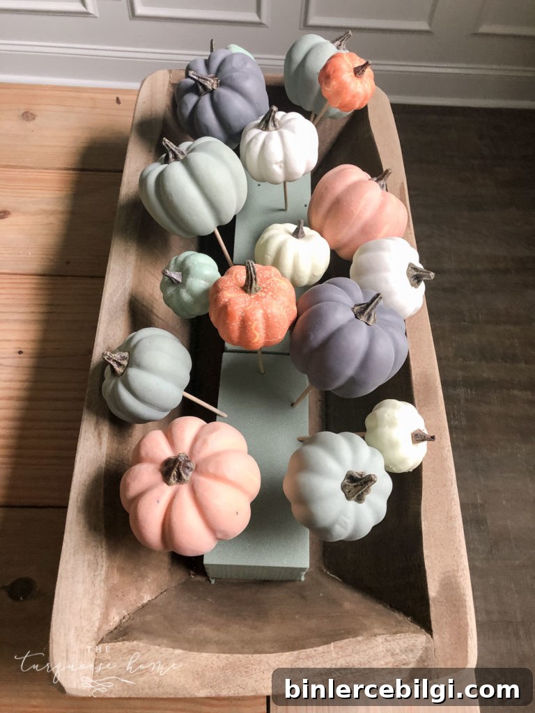 Add the smallest pumpkins to the floral foam