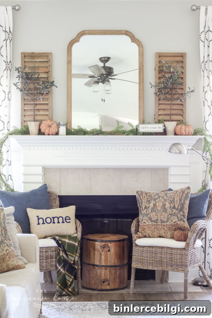 Beautiful neutral fall mantel with blues and browns and beautiful fall greenery.