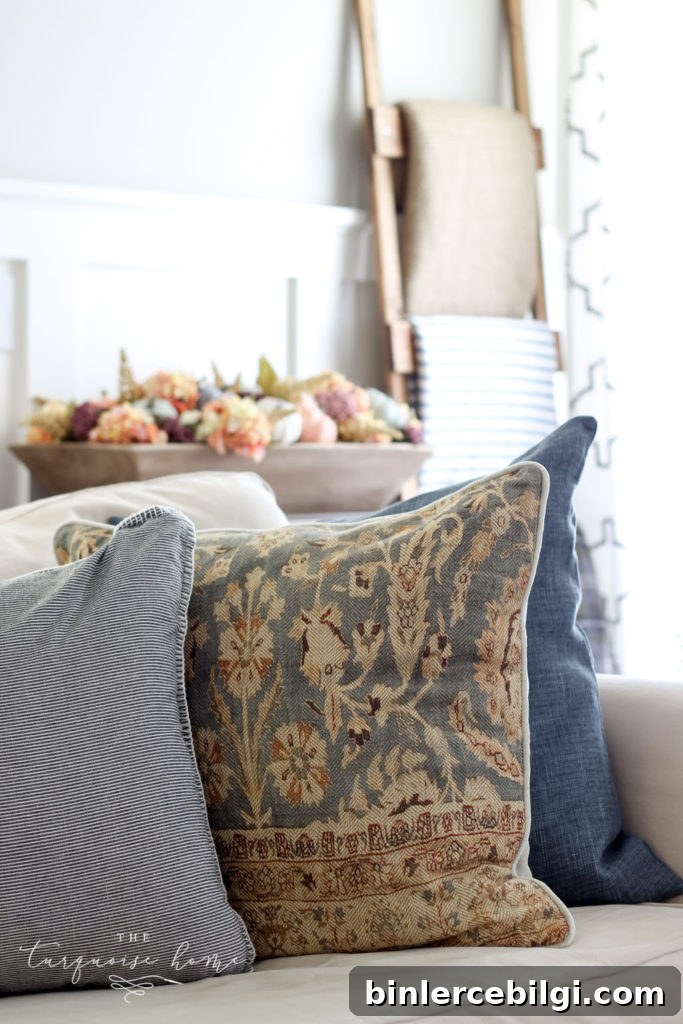 Neutral fall decor with some small pops of jewel tones - bring a cozy, yet fun vibe to this fall living room decor.