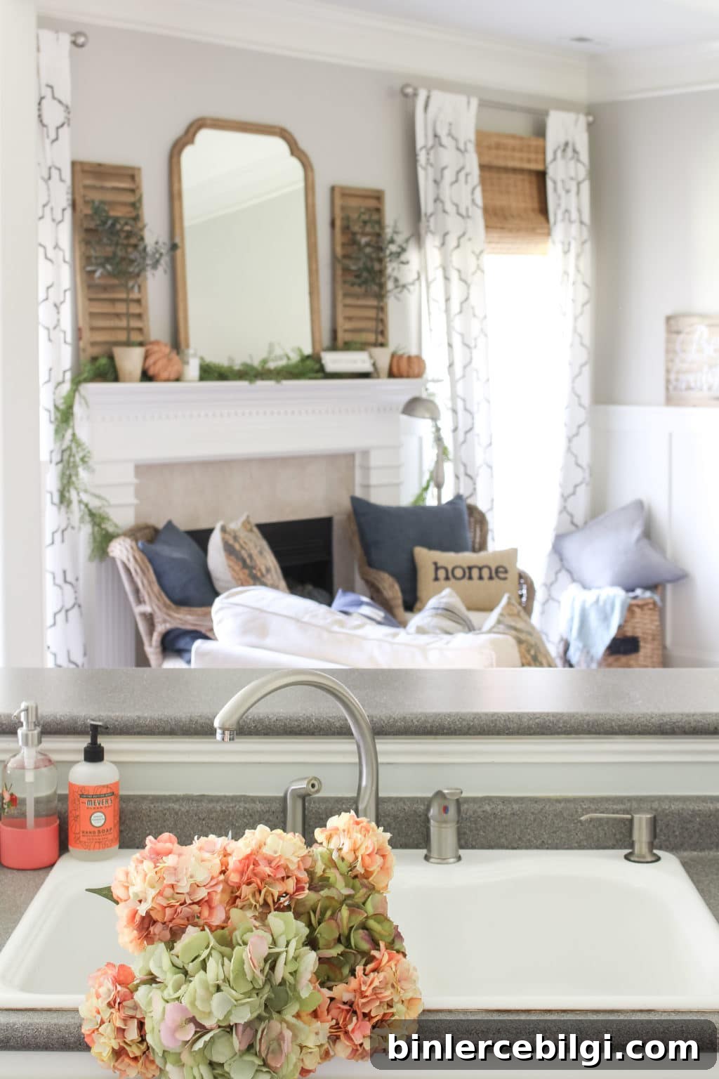 Green and coral pink hydrangeas grace the white sink in a cozy fall kitchen. Lots of fall home decor ideas in this post! 