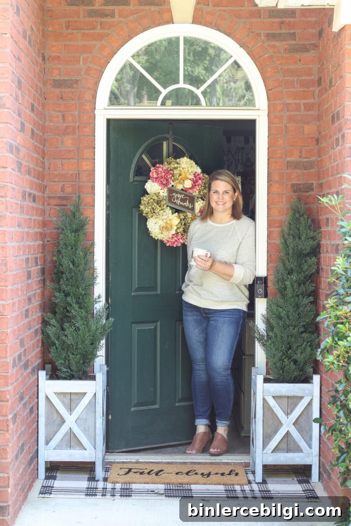 Cozy fall home tour with simple decor ideas for anyone on any budget! Hydrangea wreath, tall evergreen topiaries, fall-elujah doormat.