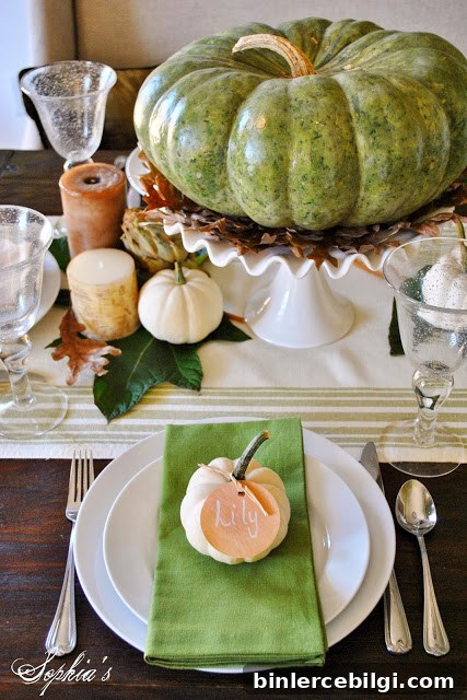 elevated pumpkin in the center of a thanksgiving tablescape