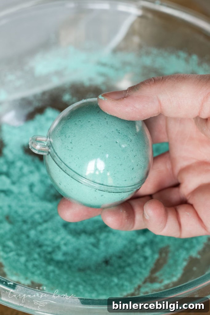How to Make Bath Bombs with a Free Printable Gift Tag 9 DIY Bath Bombs - add mixture to each side of the mold and then press them together