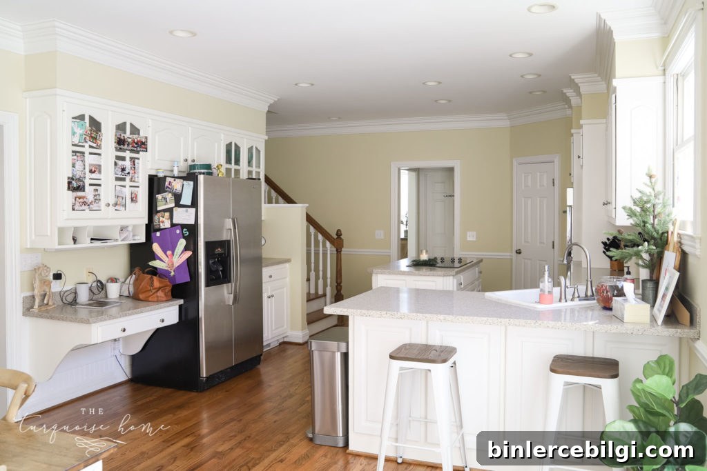 Large kitchen with white cabinets and working island. 