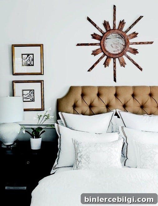 sunburst mirror hanging on the wall above a bed