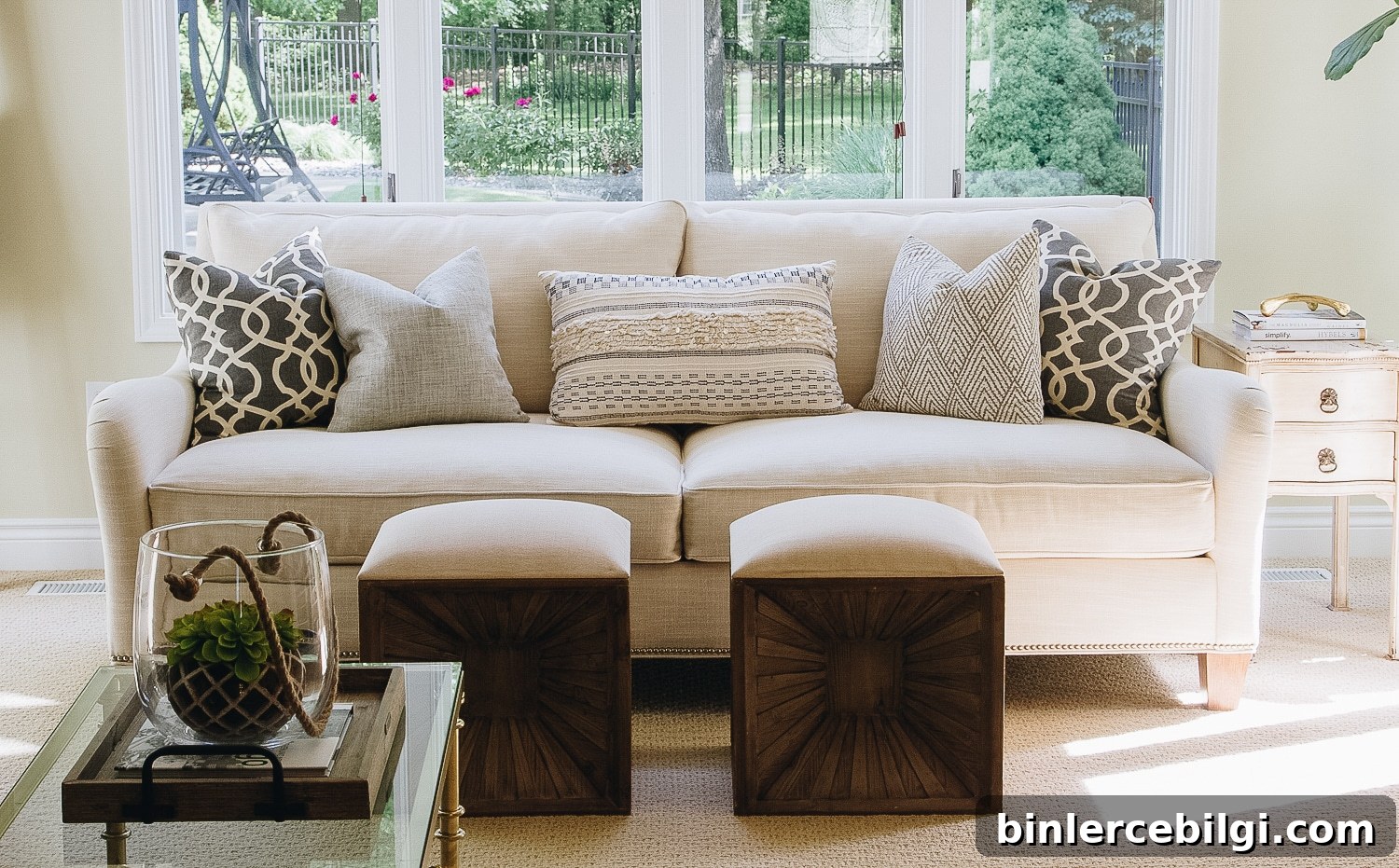 living room with couch sitting in front of windows and throw pillows on the couch