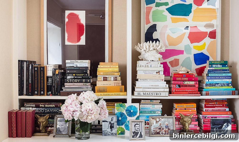 shelving decor with flowers, trinkets and books stacked according to color